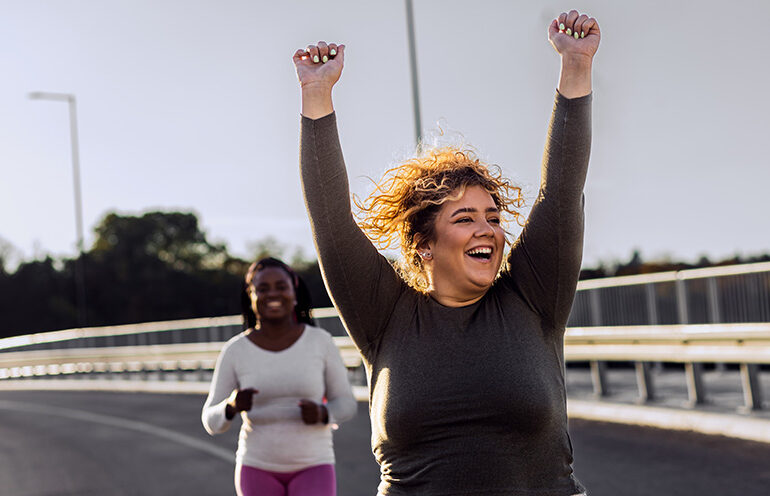 Two women go running and appreciate what their bodies are capable of doing, a core tenet of body positivity.