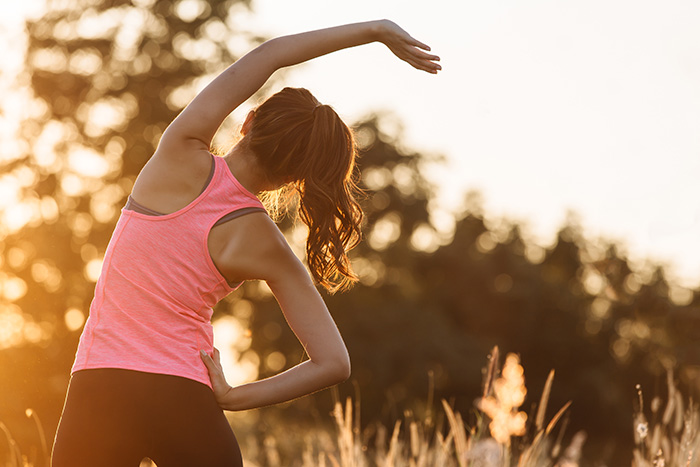 A woman prepares to exercise, one of many self-care strategies for women in recovery.