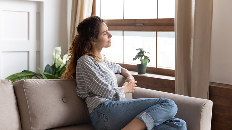 A woman is at a transitional living space.