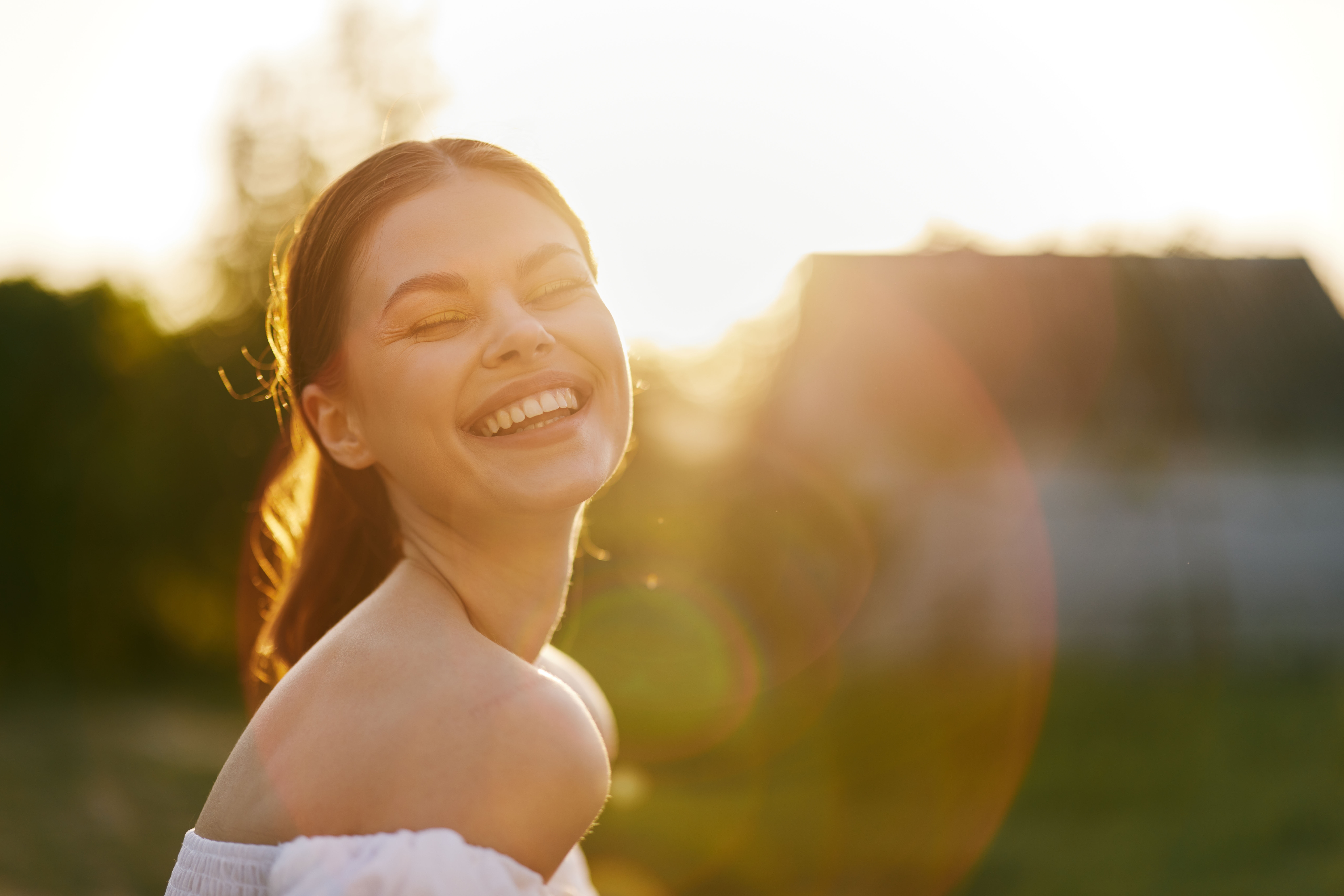 Woman smiling outdoors after attending eating disorder and trauma treatment.