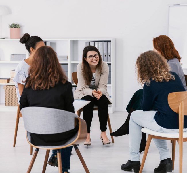 A group of women participate in therapy as part of an alcohol rehab program.